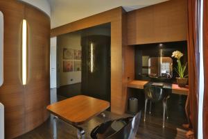 a dining room with a wooden table and chairs at Palace Hotel Moderno in Pordenone