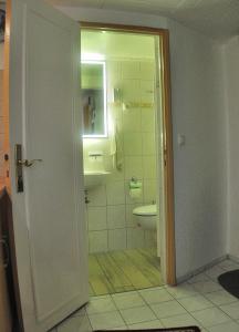 a bathroom with a toilet and a sink at Appartement Am Schulwald in Büsum