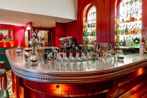 a bar with a lot of bottles of alcohol at Romantik Jugendstilhotel Bellevue in Traben-Trarbach +77 photos
