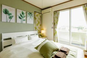 Beach House Villa Kashima tesisinde bir odada yatak veya yataklar