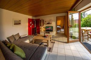 a living room with a couch and a table at Haus Bergblick in Oy-Mittelberg