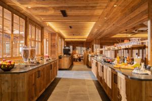 a large kitchen with wooden floors and wooden walls at Hotel Adler - Paulas Alb in Ehingen