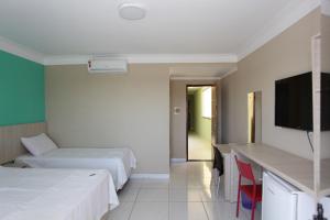 Säng eller sängar i ett rum på Pousada Portal da Cidade