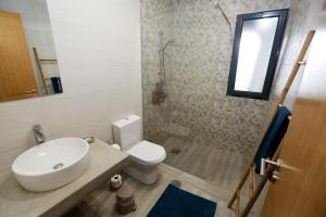 a bathroom with a sink and a toilet and a shower at Casa do Califórnia in Ribeira Grande +23 photos