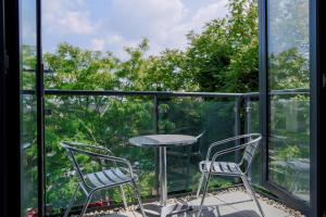 a patio with two chairs and a table on a balcony at Oakdale at Cardinal Place in Woking