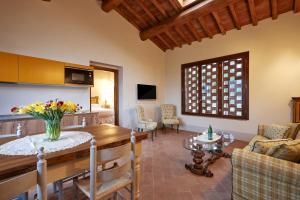 a kitchen and living room with a table and chairs at Podere di Moiata in Campestri