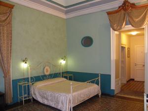 A bed or beds in a room at Il Gattopardo House