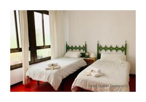バレンシアにあるB&B Una Habitación Propiaのベッド2台(タオル2枚付)が備わるドミトリールームです。