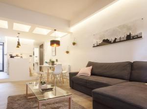 a living room with a couch and a table at Mirasol apartament en Bilbao la vieja by Urban Hosts in Bilbao