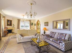 a living room with two couches and a table at Villa Cometa - Plusholidays in Calpe