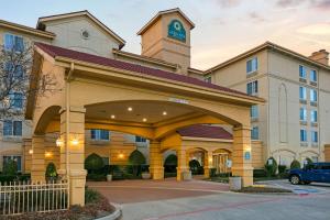 a hotel with a building with a clock tower at La Quinta by Wyndham DFW Airport South / Irving in Irving