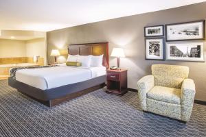 A bed or beds in a room at La Quinta by Wyndham Indianapolis South