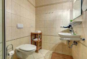 a bathroom with a toilet and a sink at Haus Meerblick - 10 in Ahlbeck