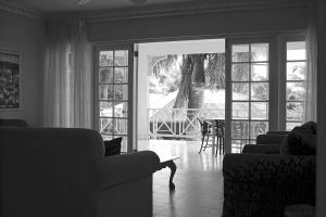 a living room with two couches and a table at Beachcomber Club Resort in Negril