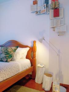 a bedroom with a bed and a lamp on a floor at Casa Azul in Óbidos