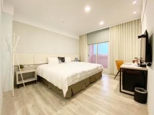 Voodi või voodid majutusasutuse Fengjia JinRui Hotel toas