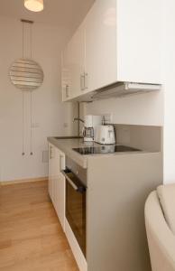 a kitchen with white cabinets and a counter top at Fewo auf der Dominsel - SEEROSE in Brandenburg an der Havel