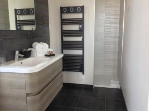 a bathroom with a sink and a mirror at La Clé du Puy in Cabariot +26 photos