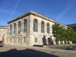 a large stone building with a tree in front of it at Royal William Yard Studio FREE PARKING & WiFi in Plymouth