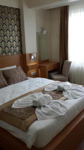 a hotel room with a bed with clothes on it at Istanbul Central Hotel in Istanbul