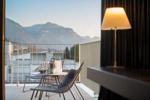 a balcony with a table and chairs on a balcony at hirschen dornbirn - das boutiquestyle hotel in Dornbirn
