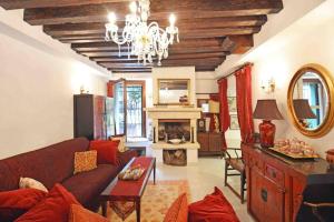 a living room with a red couch and a fireplace at Zattere Cottage close to Guggenheim in Venice