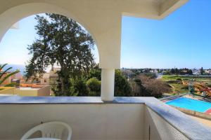 a balcony with a view of a swimming pool at LovelyStay - The Algarvean Oasis in Armação de Pêra