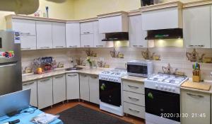 a kitchen with white cabinets and a microwave at Art House Boutique Hotel in Khiva +94 photos