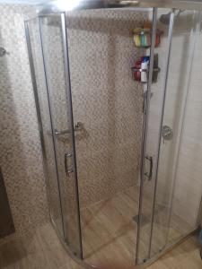 a shower with a glass door in a bathroom at Comfortable Apartment in Kato Toumpa in Thessaloniki