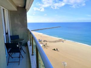 a balcony with a view of the beach at Modern Beachfront Apartment w. Magnificent Seaview in Fortaleza
