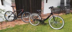 two bikes parked in the grass next to a house at Les Eygletières in Bourriot-Bergonce