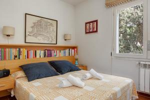 a bedroom with a bed with two pillows on it at Sa Graonada in Calella de Palafrugell