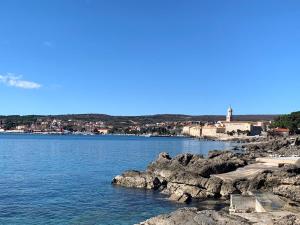 a view of a body of water with a lighthouse at Villa Lory Krk in Krk