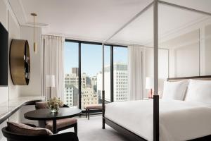 a hotel room with a bed and a large window at Four Seasons Hotel Montreal in Montreal