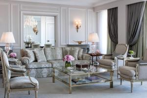 a living room with a couch and chairs and a table at Four Seasons Hotel Ritz Lisbon in Lisbon