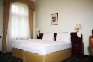 Posteľ alebo postele v izbe v ubytovaní Hotel Mignon