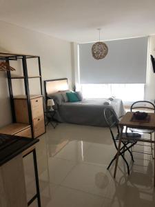 a bedroom with a bed and a table and a desk at 9 de Julio 2200 in Rosario