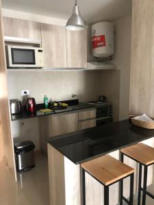 a kitchen with a counter top and a microwave at 9 de Julio 2200 in Rosario