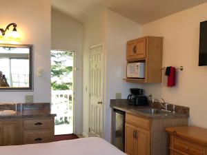 a kitchen with a sink and a microwave at The Landmark Inn in Florence