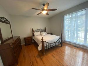 a bedroom with a bed and a ceiling fan at The La Grange House in Cleveland