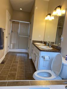 a bathroom with a toilet and a sink and a shower at The La Grange House in Cleveland