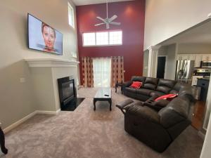 a living room with a couch and a fireplace at The La Grange House in Cleveland