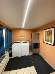 a kitchen with a stove and a refrigerator at Budget Inn in Roswell