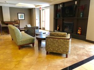 a living room with chairs and a fireplace at Holiday Inn Express Hotel & Suites Vacaville, an IHG Hotel in Vacaville