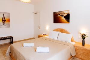 Postel nebo postele na pokoji v ubytování Nikos Hotel