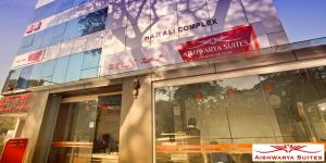 a store front of a building with signs on it at Aishwarya Suites in Mysore