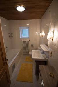 a bathroom with a tub and a sink and a bath tub at Haus Bergland in St. Wolfgang