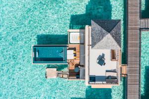 an aerial view of a resort with a swimming pool at Angsana Velavaru In-Ocean Villas - All Inclusive SELECT - Limited time offer Book 3 Nights and get 2 additional Nights Complimentary extension stay in Beachfront Villa with Half Board Meal Plan in Dhaalu Atoll