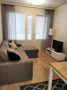 un soggiorno con divano e TV di Siljonportti Apartments a Rovaniemi