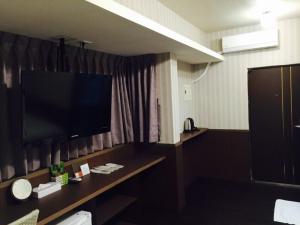 TV a/nebo společenská místnost v ubytování Love Feng Jia Apartment Hotel